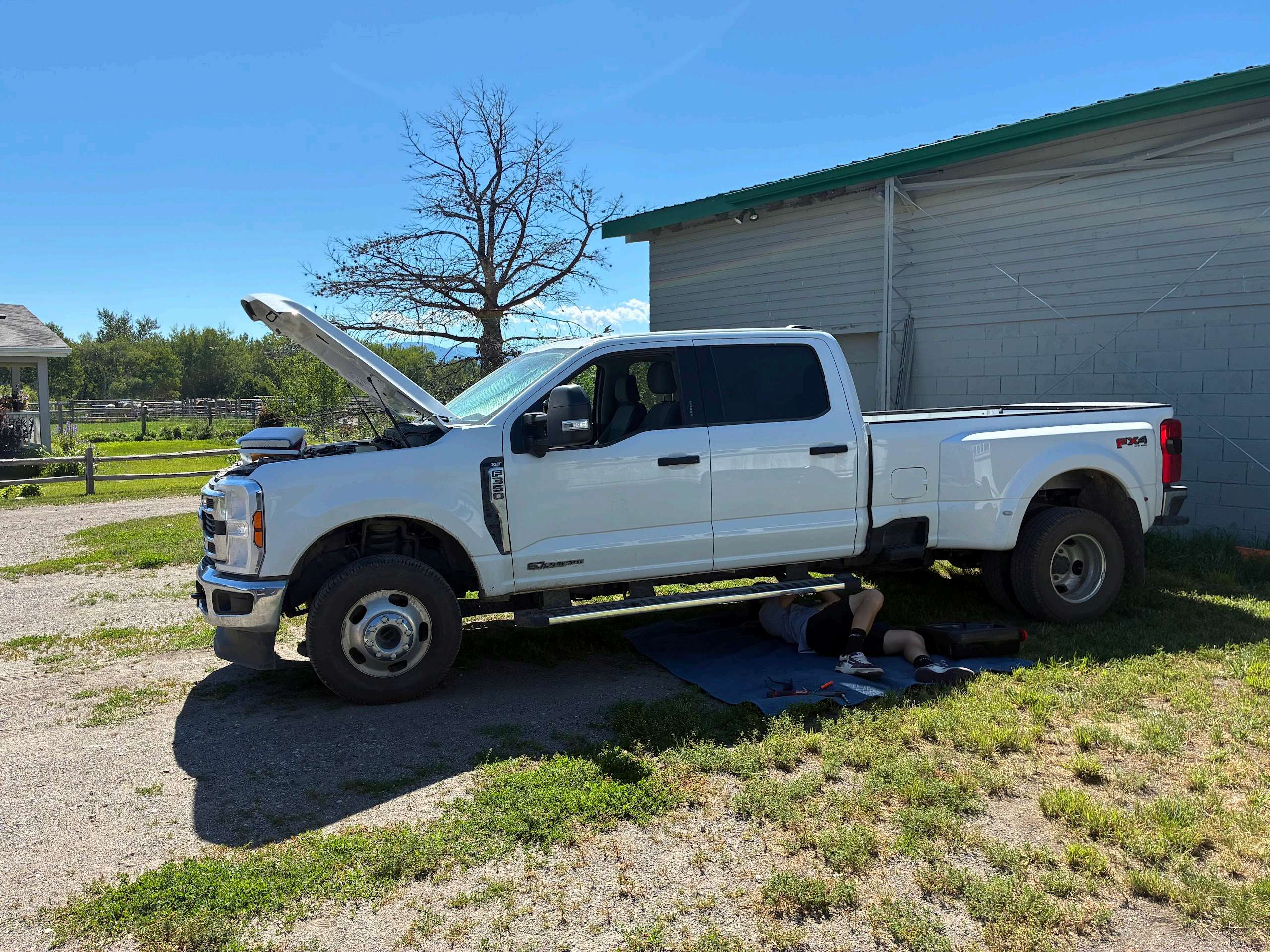 Hardline Automotive servicing a Ford F-350 diesel on-site in rural Montana